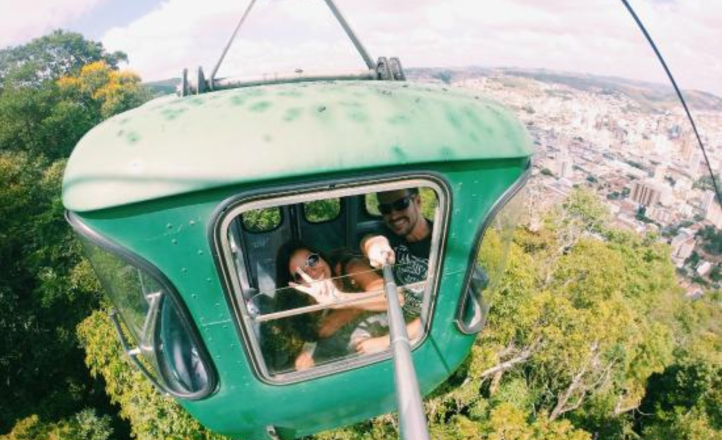 Guia Completo do Teleférico de Poços de Caldas: História, Vista Panorâmica e Dicas de Visitação 2 Vista panorâmica de uma cabine do Teleférico de Poços de Caldas subindo em direção à Serra de São Domingos com a cidade ao fundo
